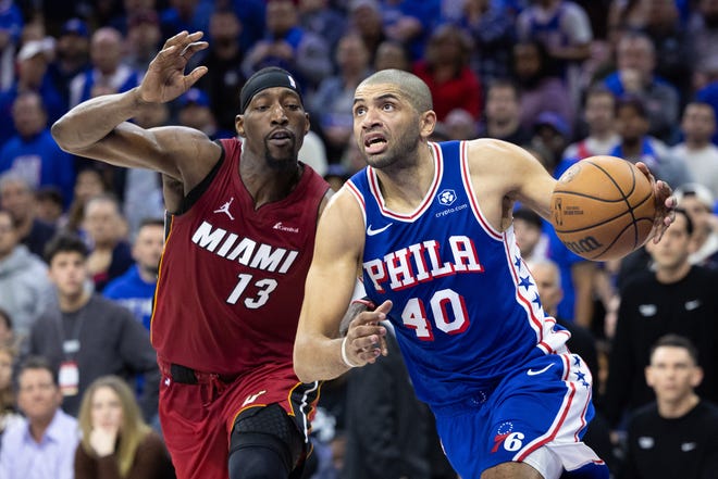 Philadelphia 76ers forward Nicolas Batum (40) drives past Miami Heat center Bam Adebayo (13) during the fourth quarter of a play-in game of the 2024 NBA playoffs at Wells Fargo Center on April 17, 2024.