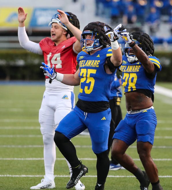 Delaware's (from left) quarterback Ryan O'Connor and running backs Kaelin Costello and Saeed St. Fleur celebrate a score during the Blue and White Spring Game at Delaware Stadium, Friday, April 19, 2024.