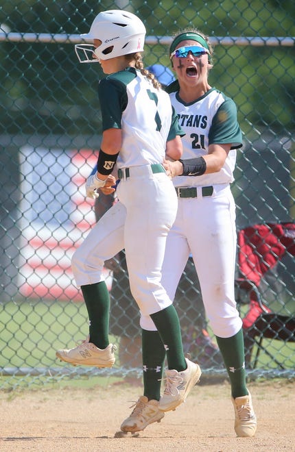 St. Mark's Sophia Wenger (left) and Ryleigh Thomas meet at home after Wenger scored the game's first run in the second inning in the Spartans'  4-0 win in the second round of the DIAA state high school tournament Wednesday, May 19, 2021 at St. Mark's High School.