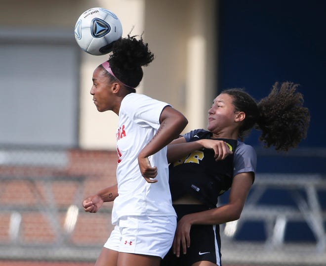 Smyrna's Desiree Zapata (left) and Padua's Sydni Wright move for a header in the first half of Padua's 2-1 win in the DIAA Division I state tournament title game Tuesday, June 1, 2021 at Dover High School.