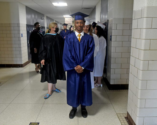 Seaford High School's Tai'shaun Abbott stands at the front of the line for commencement Monday, June 7, 2021, at Bob Dowd Stadium in Seaford, Delaware.