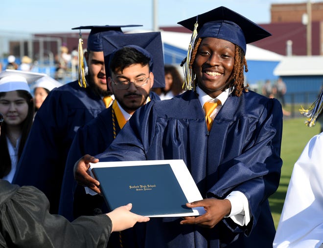 Seaford High School's Demetrez Cannon receives his diploma during commencement Monday, June 7, 2021, at Bob Dowd Stadium in Seaford, Delaware.