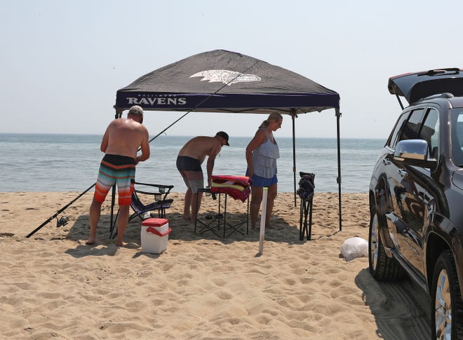 Brent Guyer and Michelle Castelli pack up after spending the morning surf fishing Friday, July 16, 2021, on Fenwick Island State Park in Fenwick Island, Delaware.