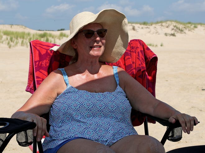 Jeri Nickel relaxs while surf fishing with family and guests Friday, July 16, 2021, on Fenwick Island State Park in Fenwick Island, Delaware.
