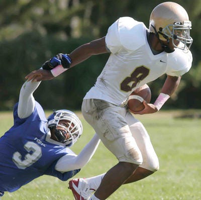 Andre Patton breaks a tackle during a 2012 game while at St. Elizabeth.